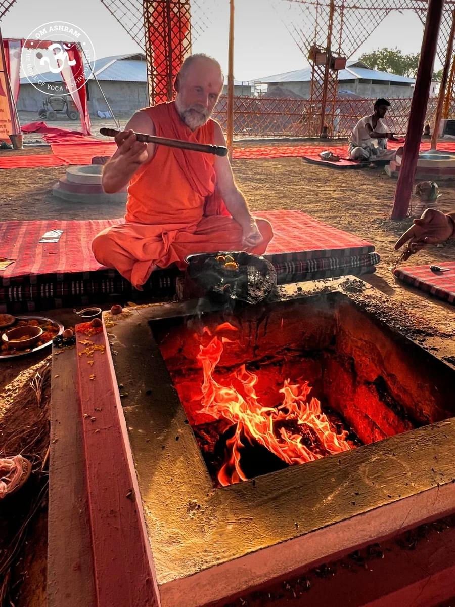 Swami Ramanand Puri Ji performing fire ceremony at the central dhuni.